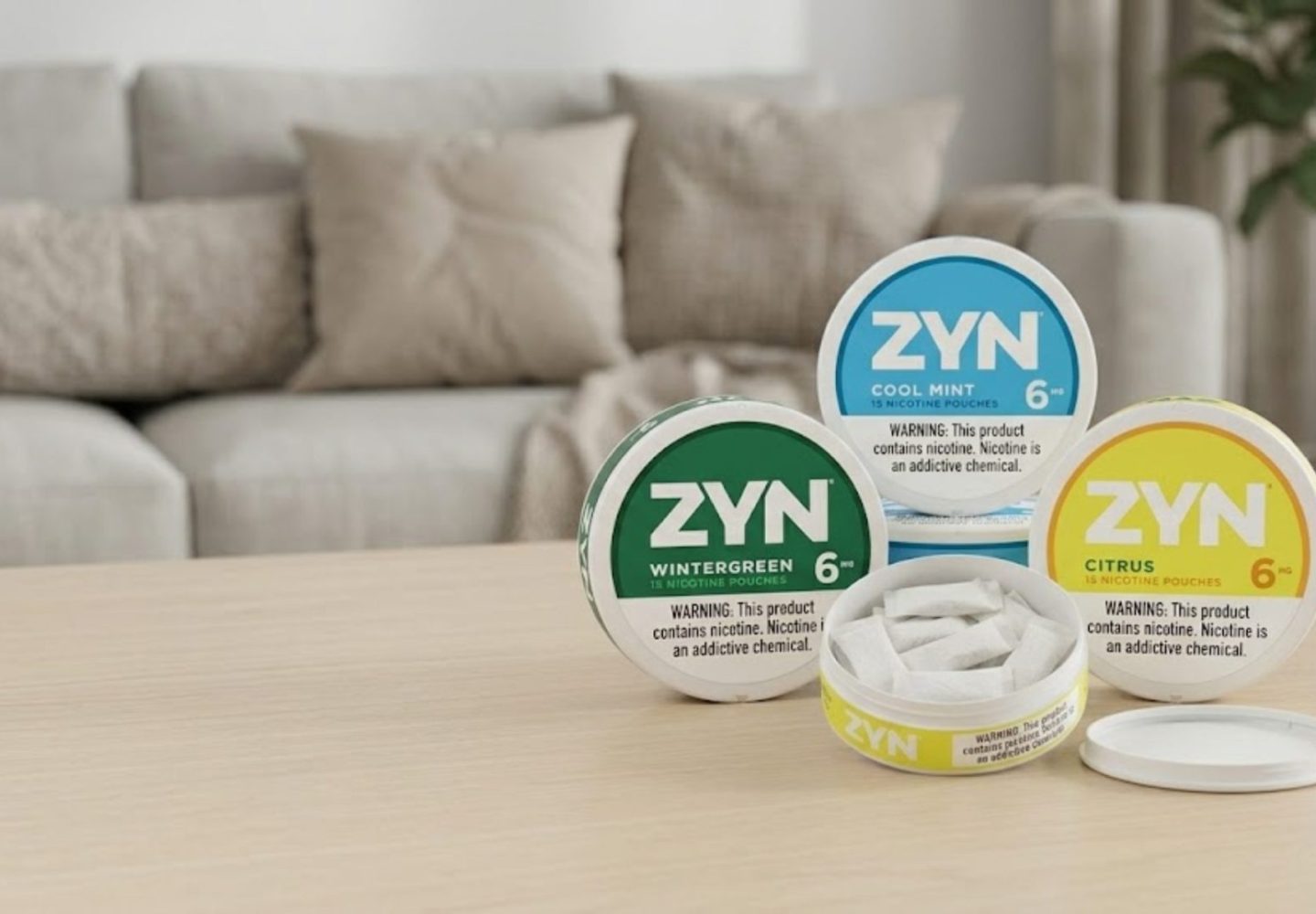 ZYN nicotine pouches in branded cans with one open can showing all-white pouches on a clean table, illustrating a discreet, tobacco-free, smokeless nicotine option for adult users.